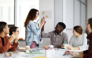Newburg CPA -accounting staff high fiving over group presentation