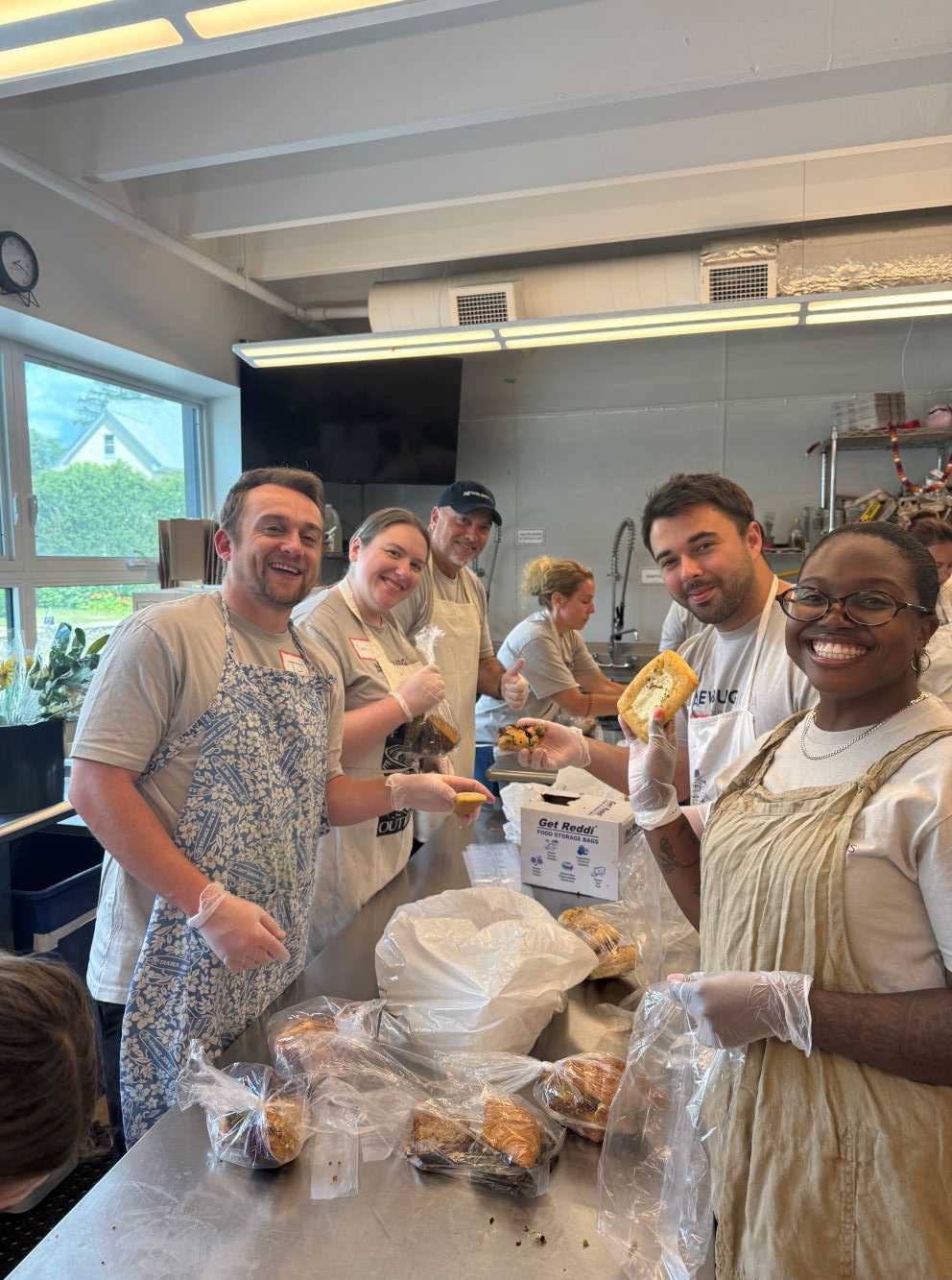 People smiling while preparing food snacks