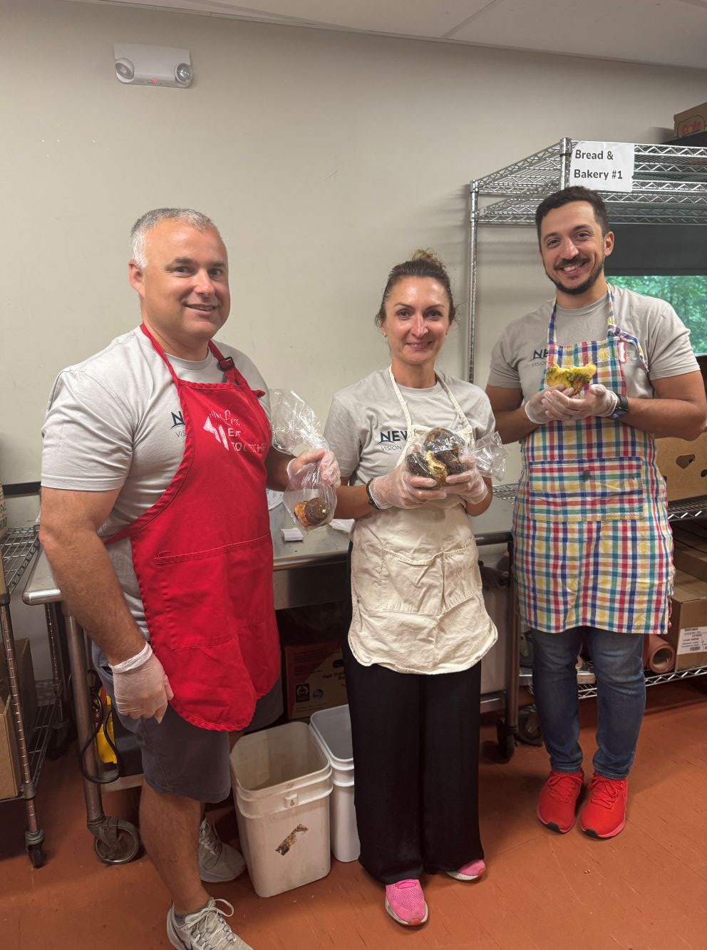 Volunteers assembling food packs in a kitchen